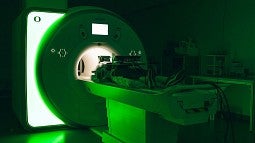 Image of MRI with patient in it, and a green hue