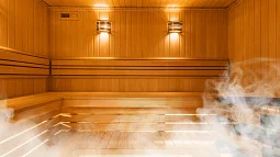 A wooden sauna with lights and some steam