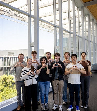 Parisa H lab photo, holding the 'O'