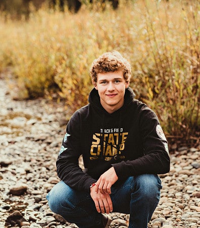 Headshot of tony Peonio, in a grass field