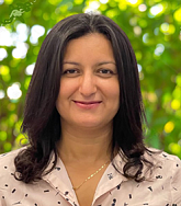 Portrait of Aida Chebbi with tree in background