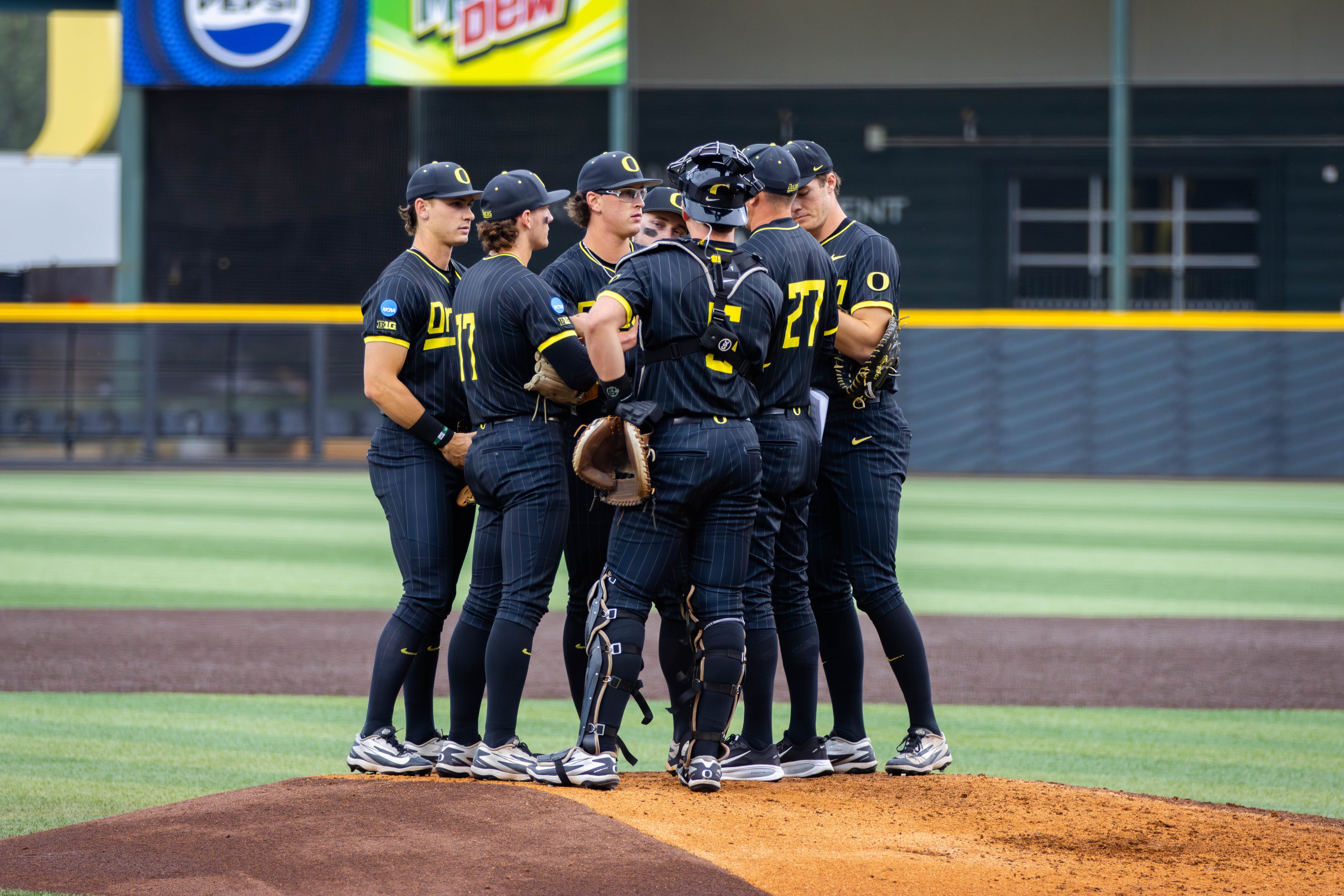 The Oregon Ducks baseball team meets at the mound during their Regional win over Yale
