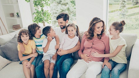 mixed family sitting on a couch together