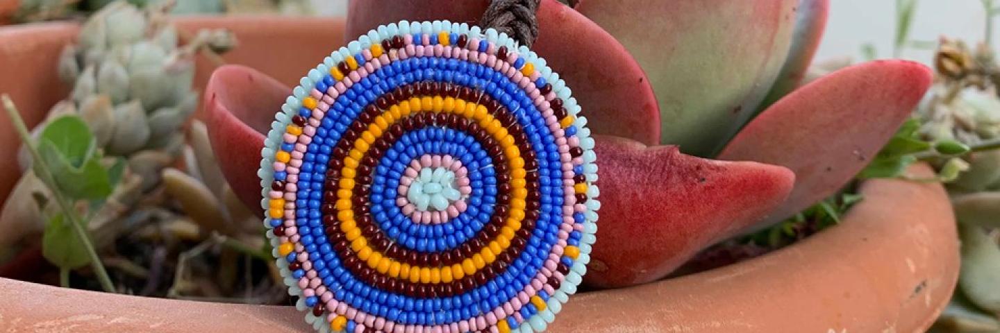 Marjorie Kalama completed beaded ornament sitting in a succulent plant