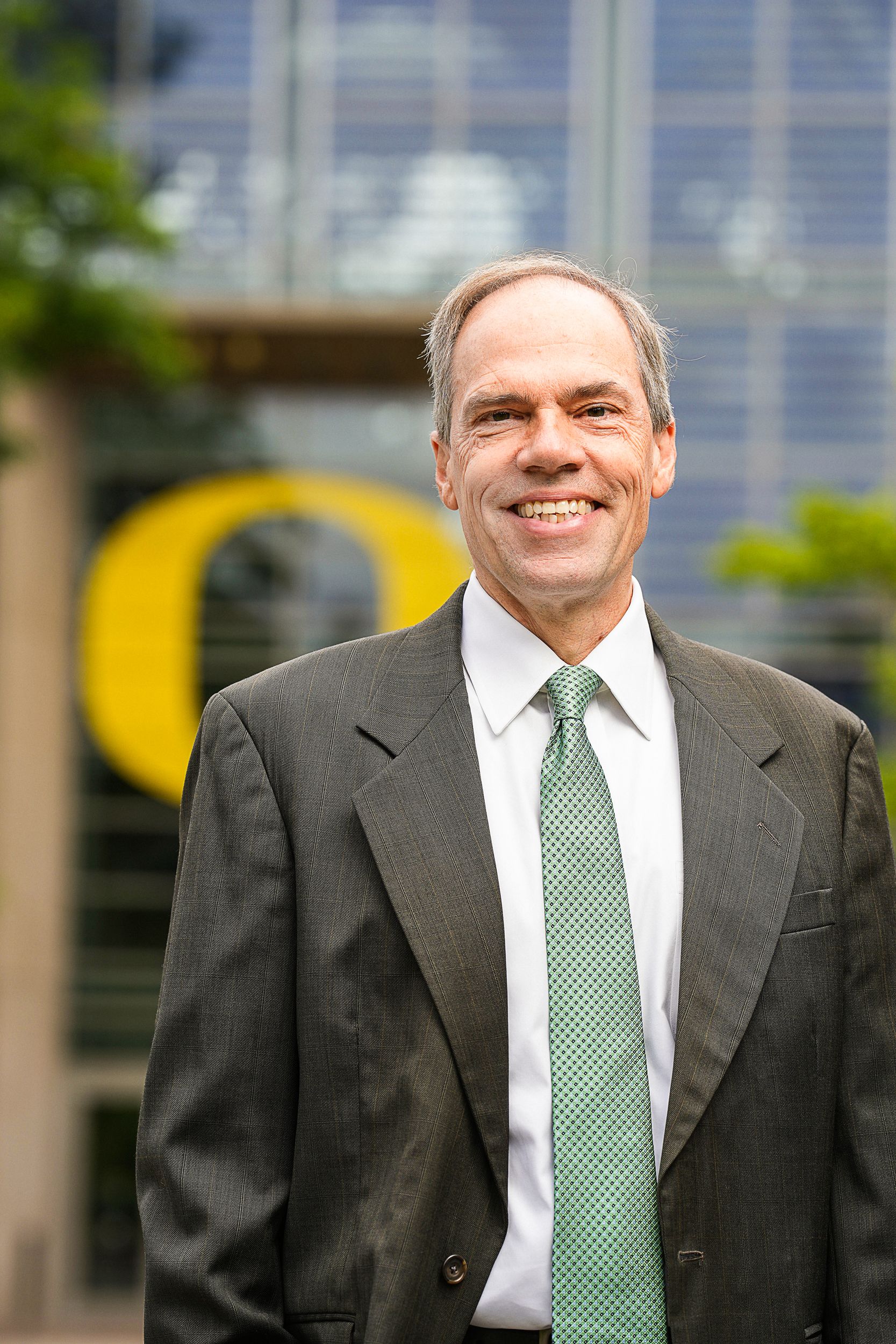 Photo of Bruce Blonigen standing outside, smiling at the camera.