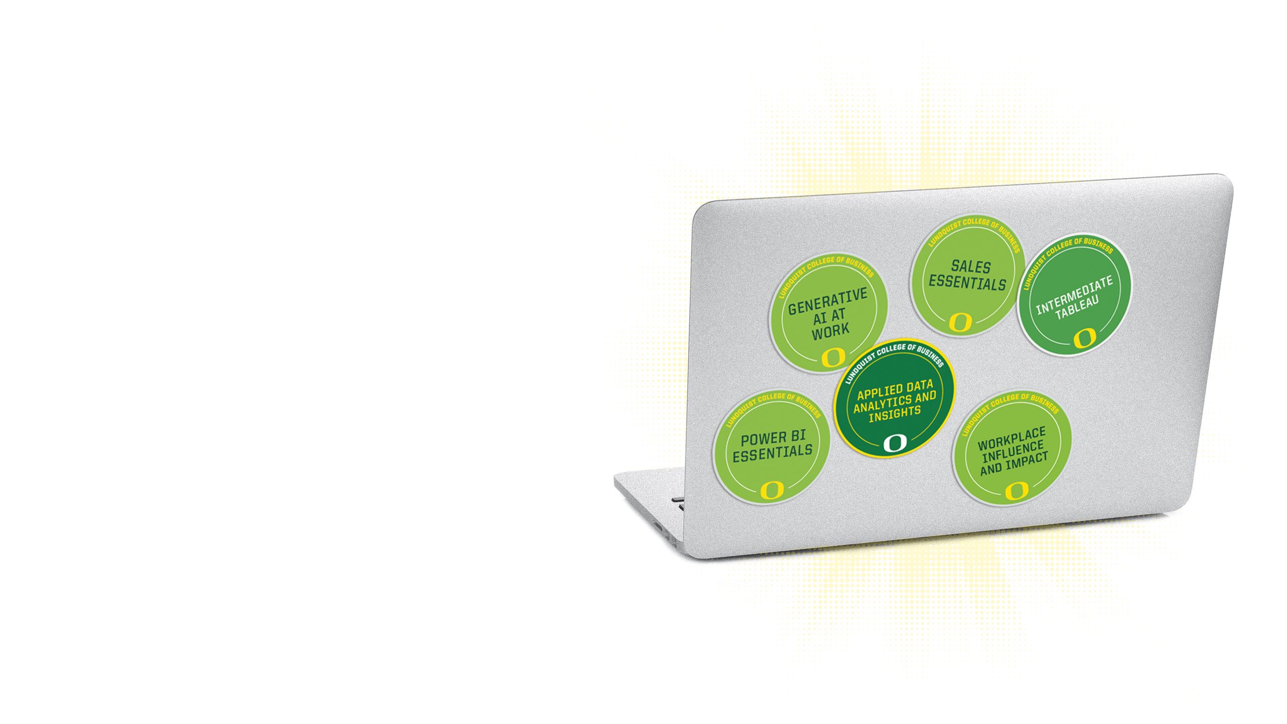 An image of the lid of a computer with multiple microcredential badges on it