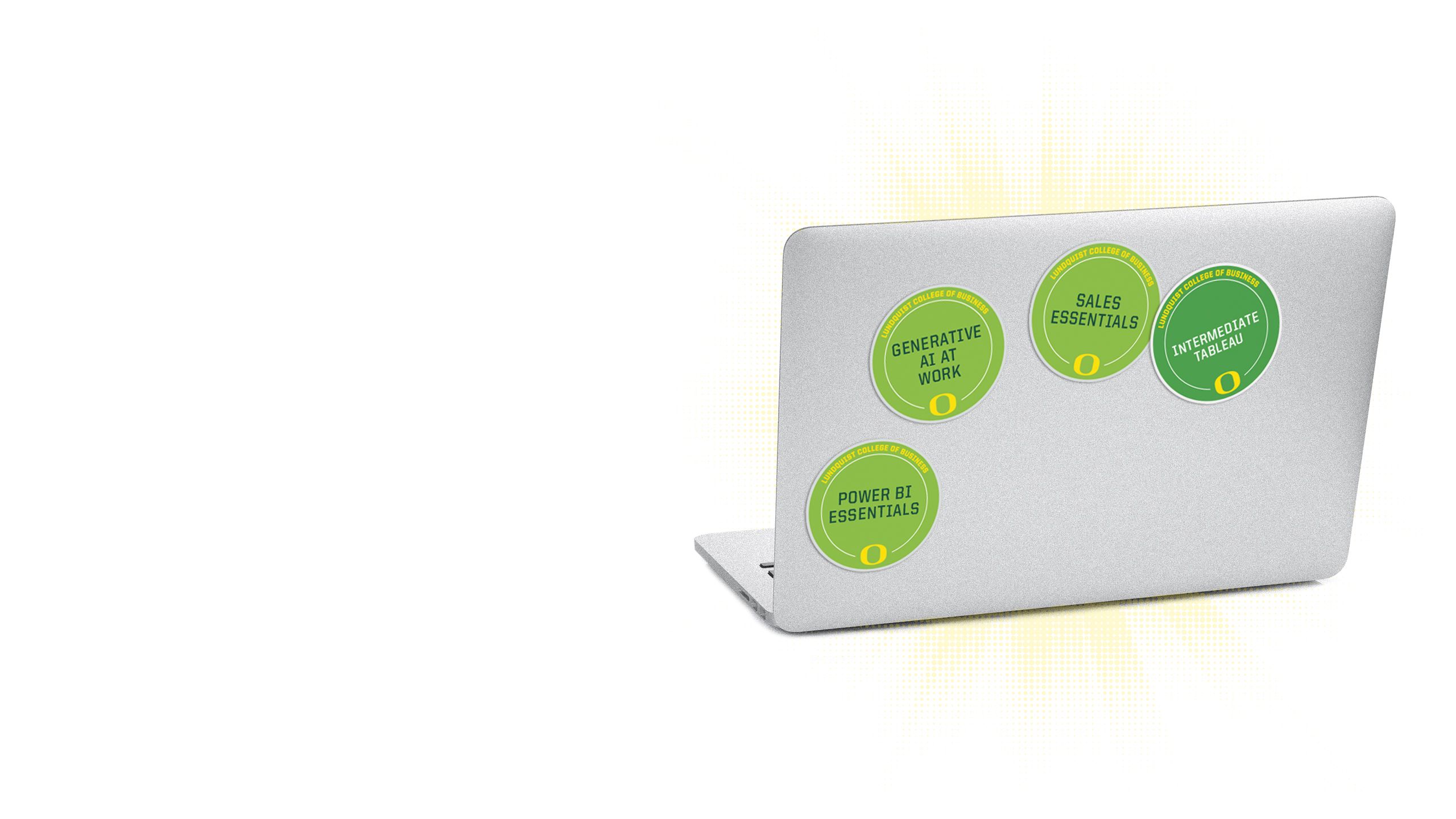 An image of the lid of a computer with multiple microcredential badges on it