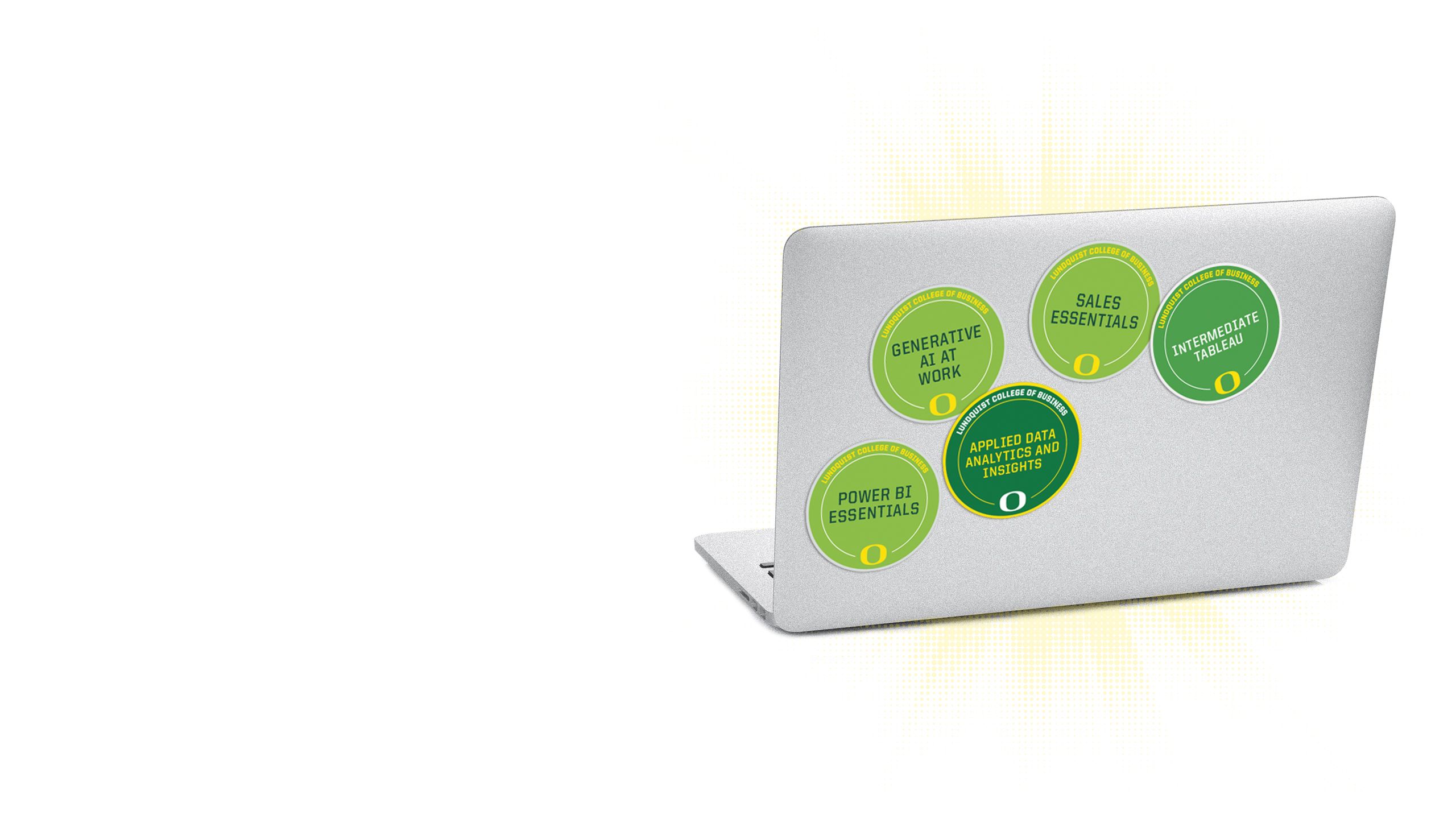 An image of the lid of a computer with multiple microcredential badges on it