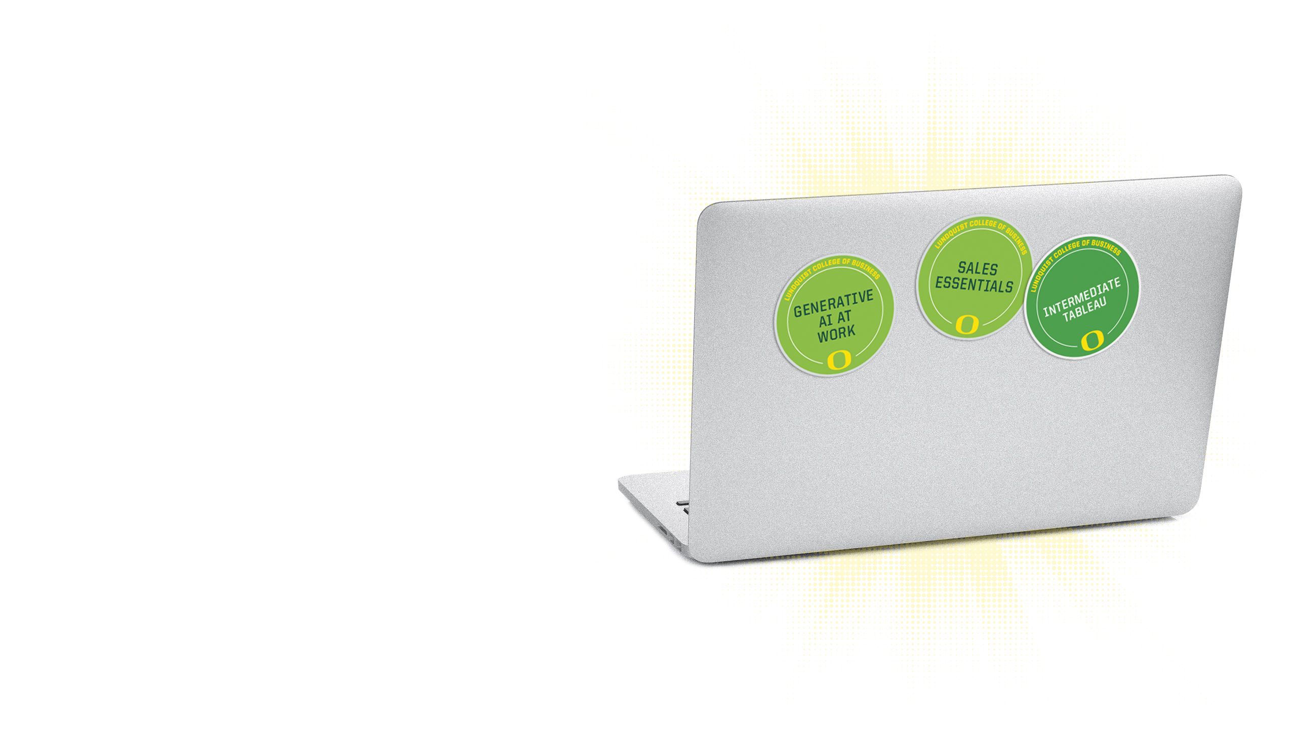 An image of the lid of a computer with multiple microcredential badges on it