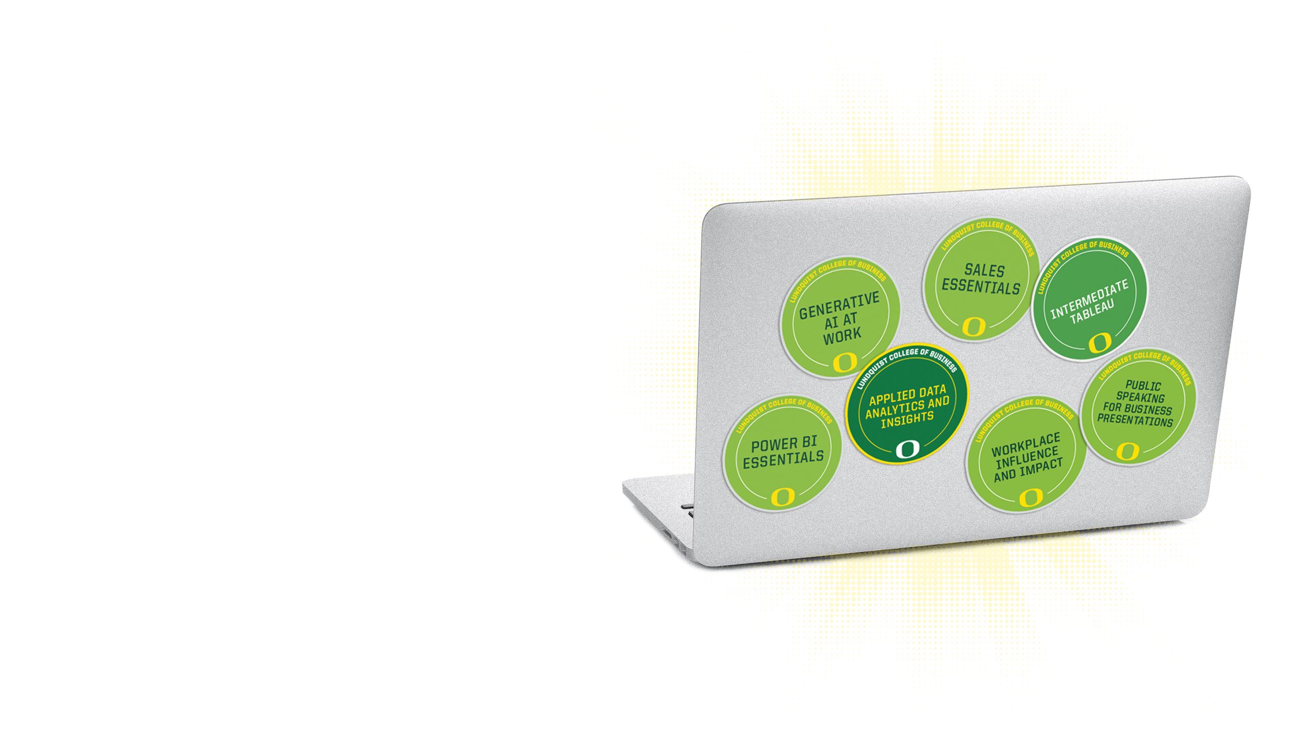 An image of the lid of a computer with multiple microcredential badges on it