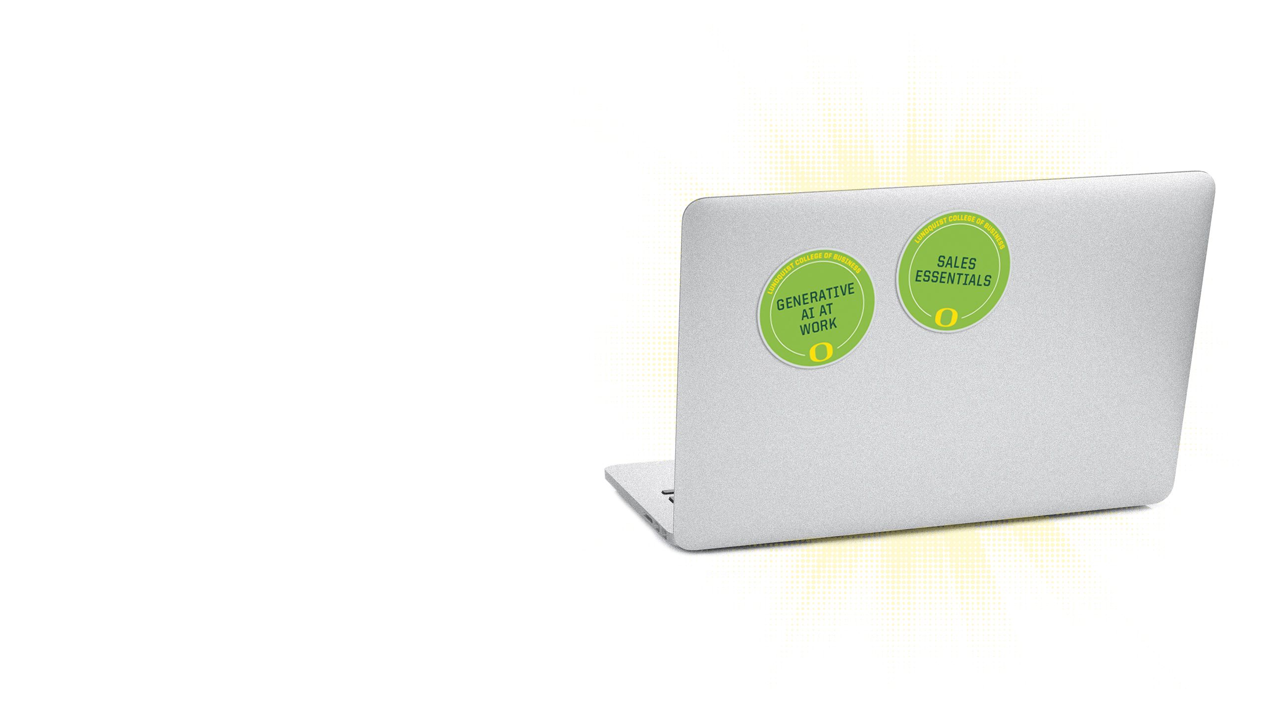 An image of the lid of a computer with multiple microcredential badges on it