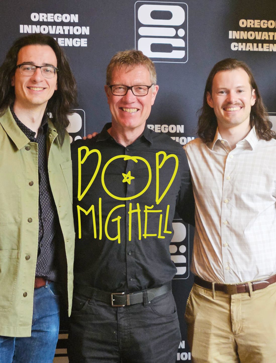 A photo of Bob Mighell smiling at the camera with two students