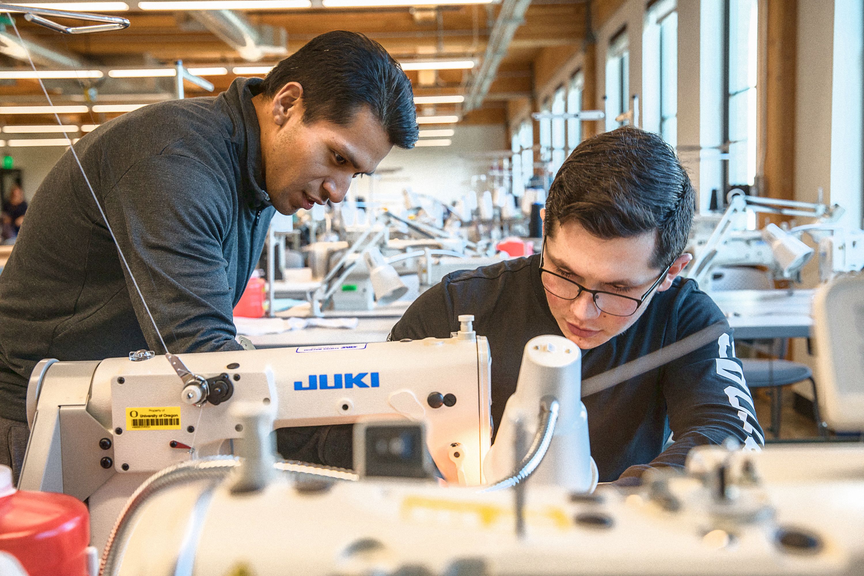 A photo of students working at a sewing machine in the SPM Innovation Lab
