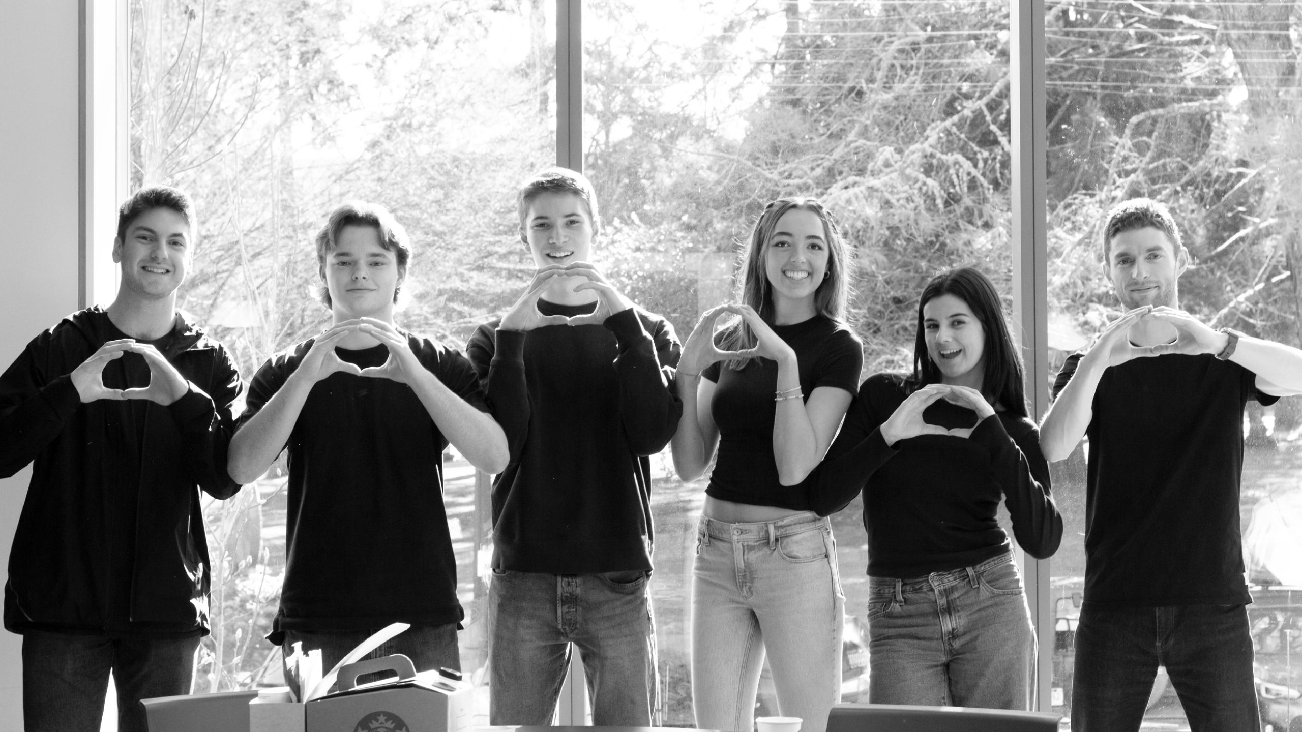 Five students and Jeff Sorensen standing, looking at the camera, with their hands in the shape of an O.