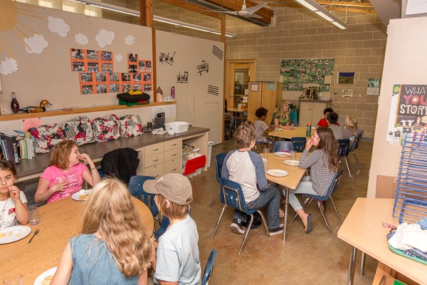 Classoom features activity tables and storage spaces.