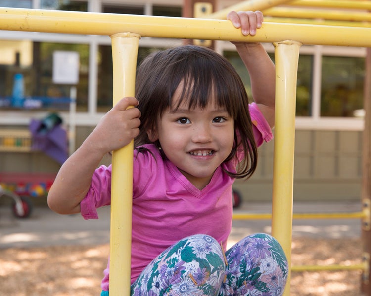 Child playing on playing on play structure.