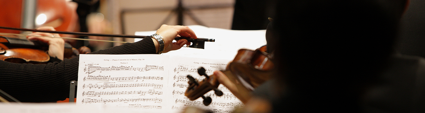music sheet in front of violinists