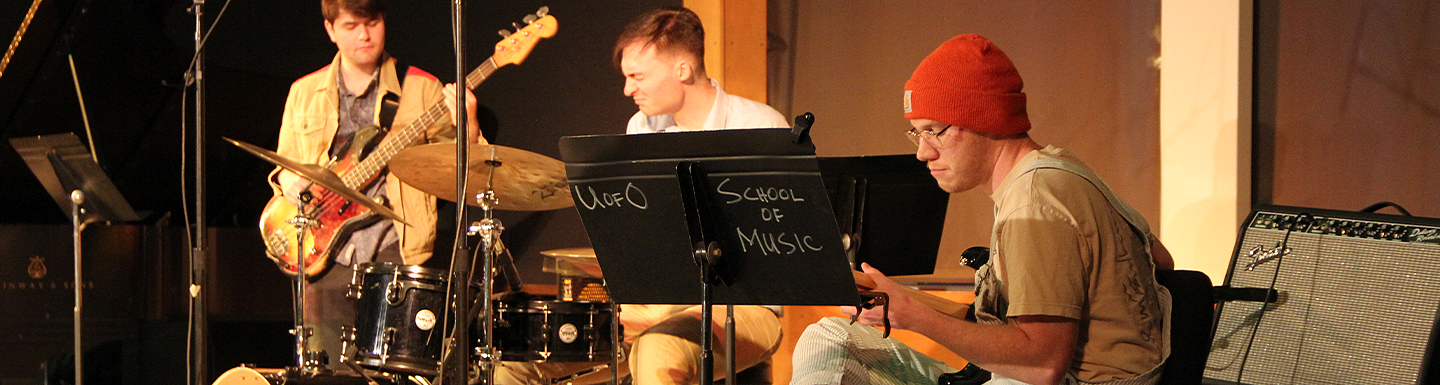 group of students playing drums and guitar