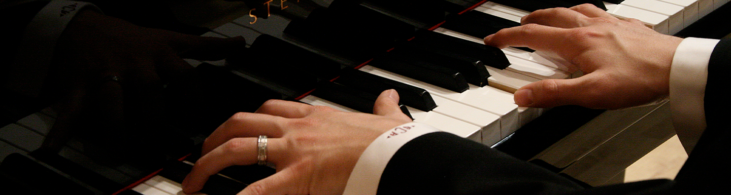 closeup of hands playing the piano