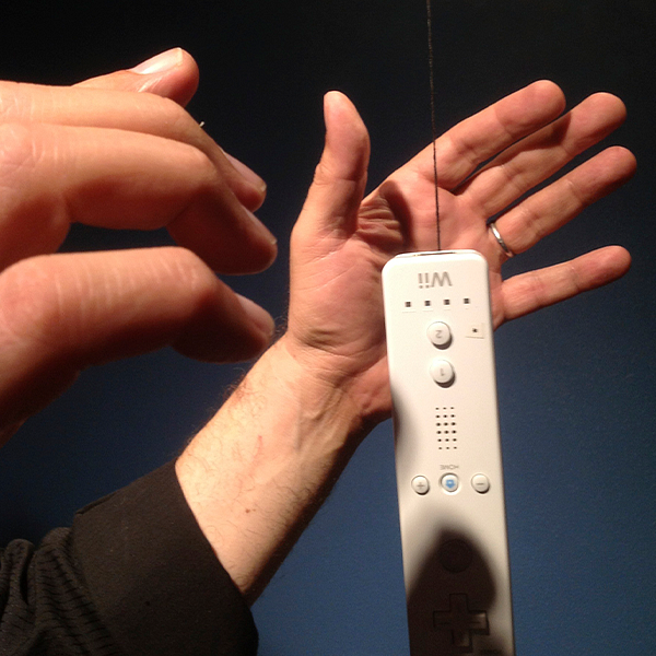 hands hovering a Wii remote