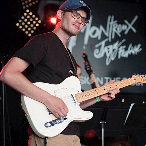 student performing guitar