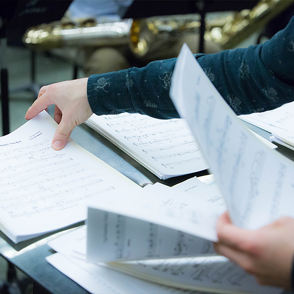 hands flipping through music sheet