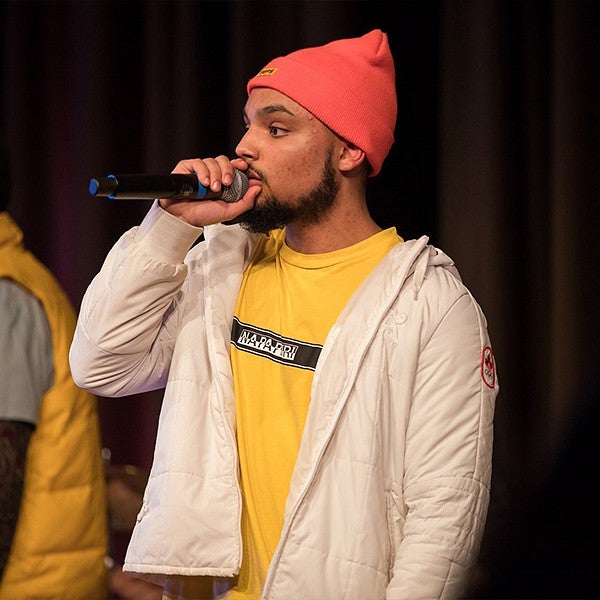 student singing holding microphone