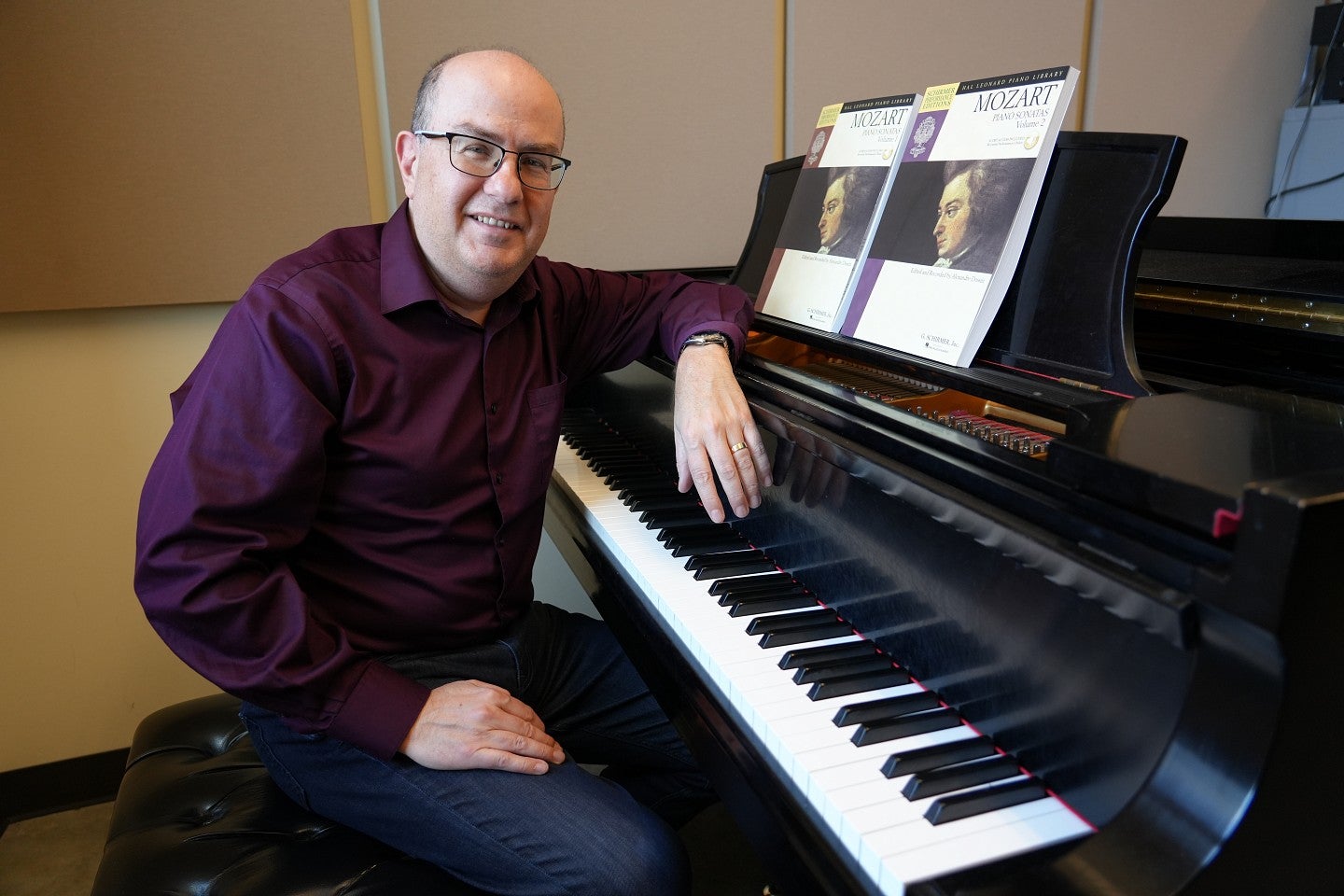 alex at a piano with the sonatas propped up