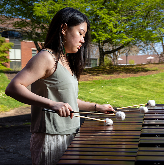 percussion student playing outside