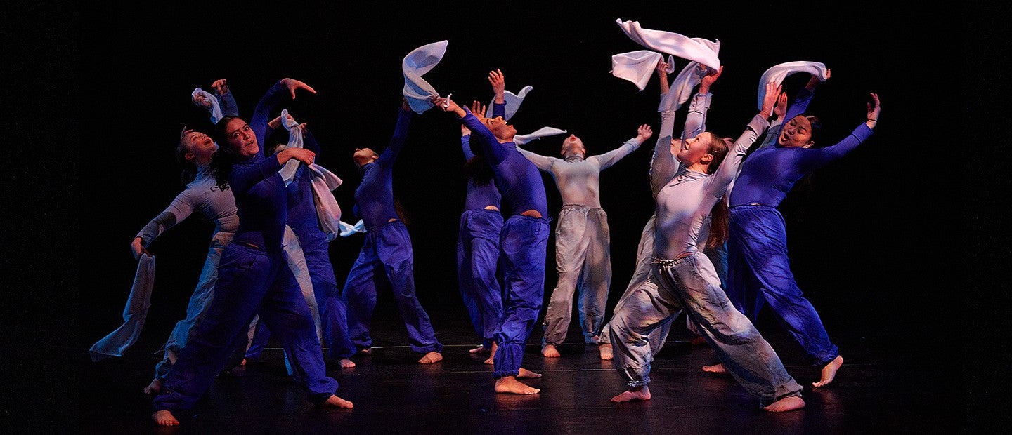 dance students with hands in the air during routine