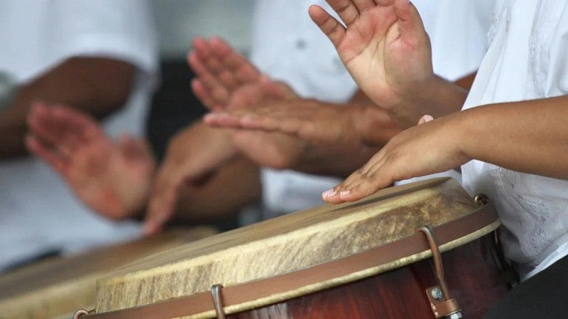 Hands playing Puerto Rican folk music on a typical Latin drums