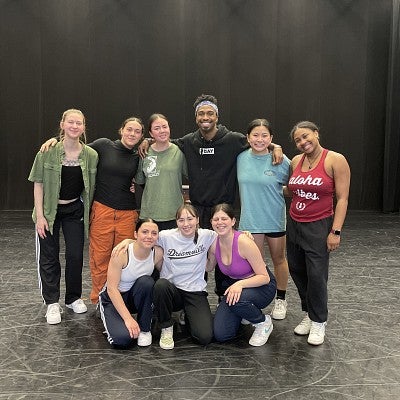Quilan Arnold posing with uo dance students
