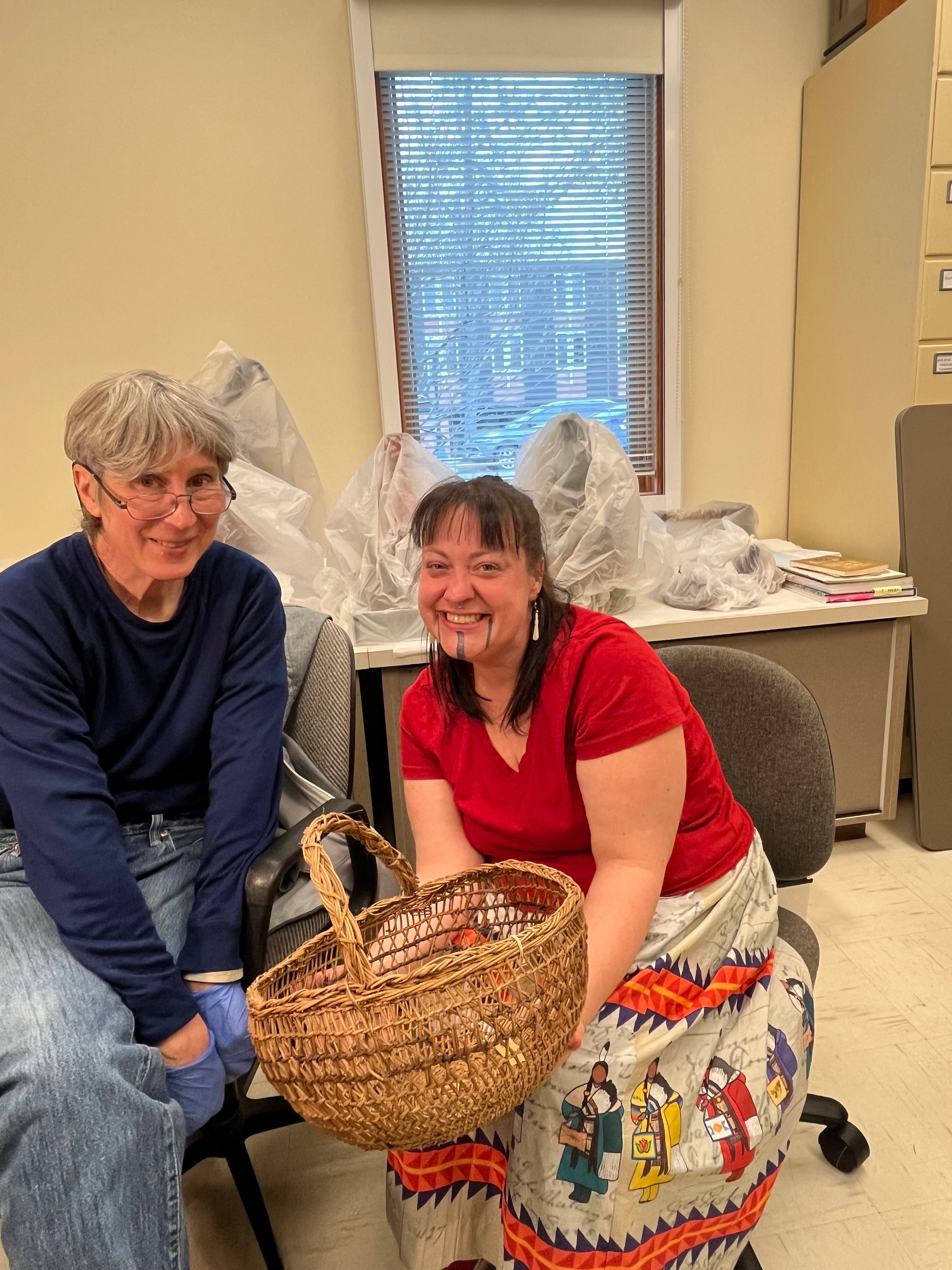 Margaret Mathewson and Stephanie Craig smile with a basket