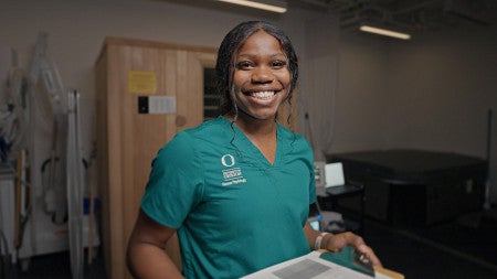 a student wearing scrubs in a lab