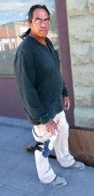 Dave Gagnon stands outside next to white masonry in Historic Baker City, Oregon. He wears a black long sleeved shirt.