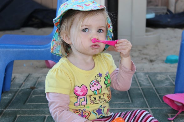 Small child blowing bubbles