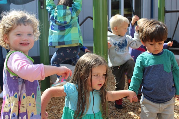 3 young children holding hands