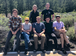 Members of the McMorran lab pose on a bench.