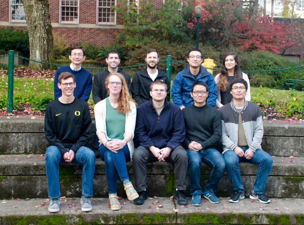 Members of the Wang lab pose on steps.