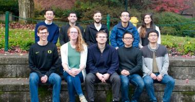 Members of the Wang lab pose on steps.