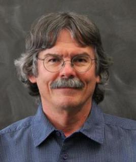 Headshot of Michael Raymer.