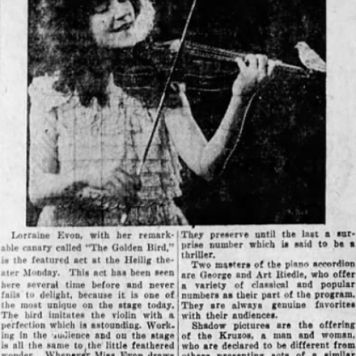Woman playing the violin along with a canary at the Heilig
