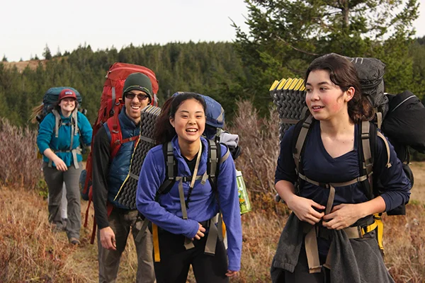 Students hiking on desert trail.