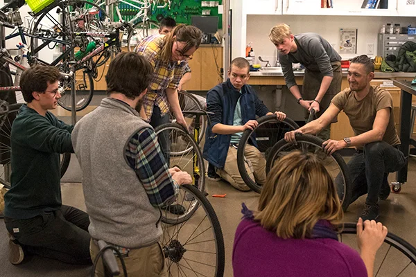 Staff reviewing bicycle maintenance.
