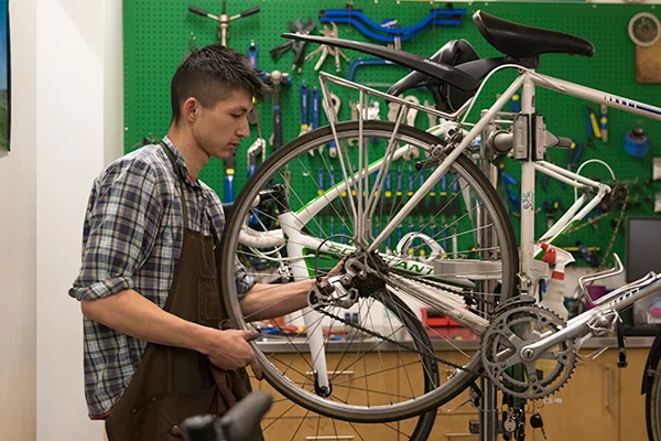Student tuning bicycle wheel.