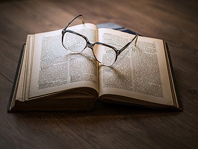 Open book with glasses
