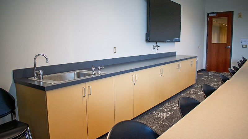 There is a sink and long counter. 