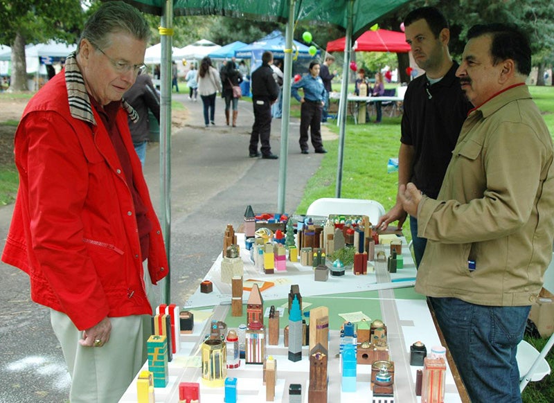 Mayor of Medford Gary Wheeler stopped by a booth set up by Assistant Professor Gerardo Sandoval