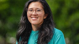 Nicole Ngo news header for research story. Shows a portrait of a woman in front of a blurry green background. Decorative. 