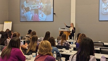 Professor Sara Schmitt, PhD in classroom of students